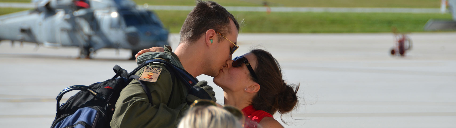 Lt. Scott Brady reunites with his wife Brittany after Helicopter Sea Combat Squadron (HSC) 25 Det 1 returned from a seven-month deployment in the Indo-Asia-Pacific region. (U.S. Navy/John McSorely)
