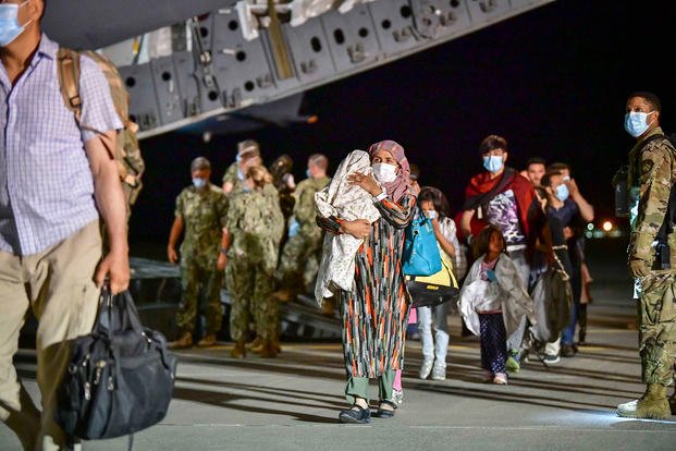 Afghan evacuees disembark a U.S. Air Force C-17 Globemaster III.