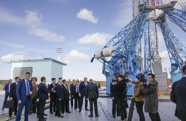 Russian President Vladimir Putin and North Korea's leader Kim Jong Un, seen center left, examine a launch pad