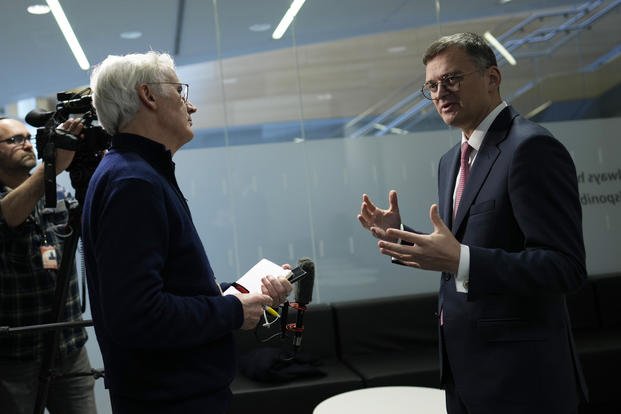 Ukraine's Foreign Minister Dmytro Kuleba, right, speaks during an interview at NATO headquarters