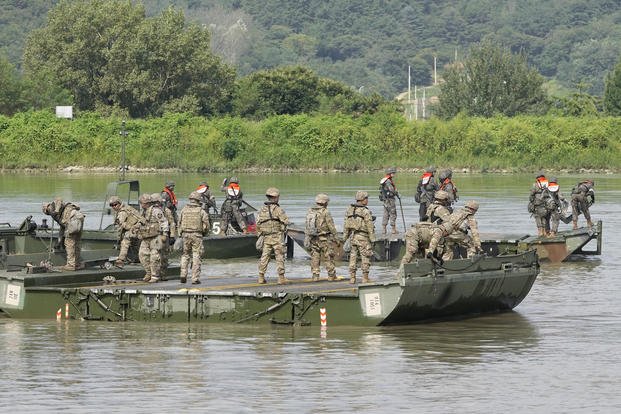 U.S. and South Korean soldiers try to connect a floating bridge