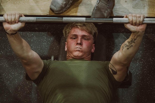 A U.S. Marine Corps corporal performs a bench press during the human health and performance initiative on Camp Lejeune, North Carolina.