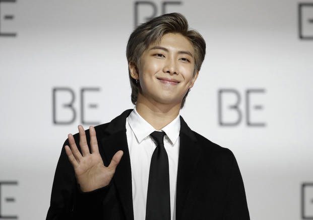 RM, a member of South Korean K-pop band BTS, poses for photographers in Seoul