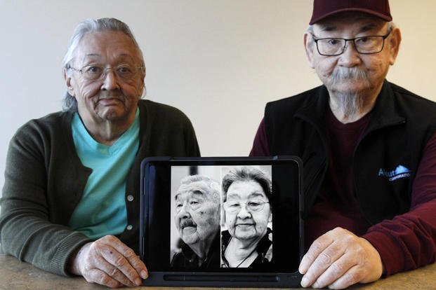 Pauline Golodoff and George Kudrin hold an iPad featuring images of their deceased spouses.