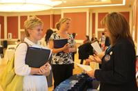 A military spouse speaks to a potential employer at the Marston Pavilion aboard Marine Corps Base Camp Lejeune during the Military Spouse Business Alliance Hiring Fair and Career Forum Aug. 9. (U.S. Marine Corps/Lance Cpl. Jackeline M. Perez Rivera)