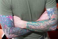 U.S. Marine displays arm tattoos.