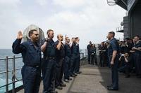 Sailors aboard USS Dwight D. Eisenhower take the oath of reenlistment.