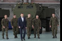 Poland's Defense Minister Mariusz Blaszczak, center, walks during a ceremony