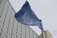 The flag of the International Atomic Energy Agency flies in front of its headquarters.