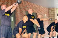 Soldiers in the Army's Future Soldier Prepatory Course's fitness track conduct afternoon physical fitness training with light kettlebells.