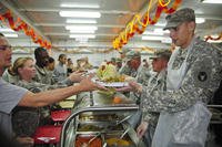 On Thanksgiving Day 2011, leaders of the 2nd Battalion, 135th Infantry (2-135 Inf.) serve the troops of 1st Brigade Combat Team, 34th Infantry Division &quot;Red Bulls&quot; on Camp Buehring, Kuwait.