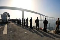 Sailors and Marines man the rails aboard the USS Boxer