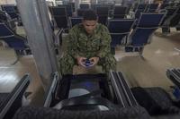 U.S. Navy sailor plays a video game aboard the USNS Spearhead