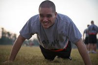 Spc. Coca Temoananui, an intelligence analyst from Honolulu, assigned to the 311th Signal Command, strains for an extra push-up in the 2012 U.S. Army Reserve Best Warrior Competition at Fort McCoy, Wis.
