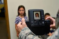 An Air Force child gets her passport photo taken at Dover Air Force Base, Delaware. (U.S. Air Force photo/Airman 1st Class William Johnson)